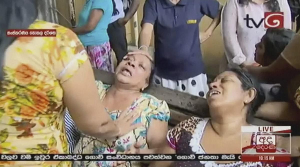 This image made from video, released by Derena TV shows women in despair after an explosion in Colombo, Sunday, April 21, 2019. Witnesses are reporting two explosions have hit two churches in Sri Lanka on Easter Sunday, causing casualties among worshipper
