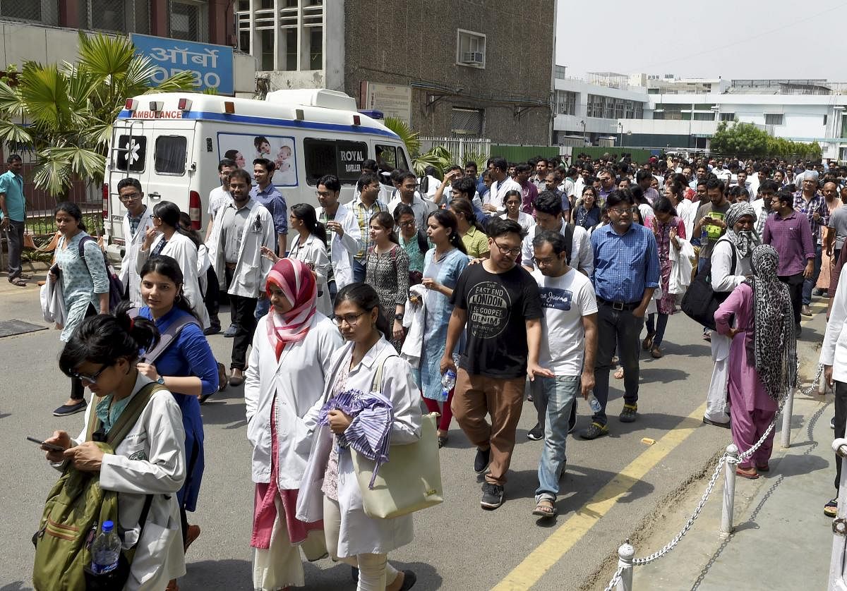Resident doctors of the All India Institute of Medical Sciences (AIIMS) leave after a sit in protest as part of their indefinite strike after a junior doctor was assaulted by a senior doctor, in New Delhi on Friday.