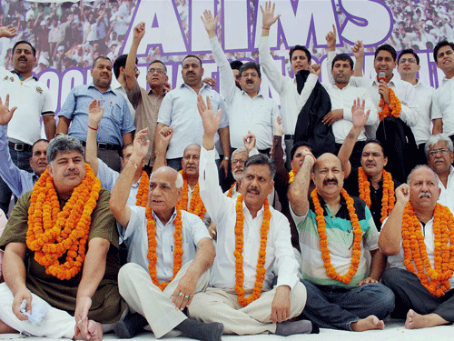 Members of AIIMS co ordination committee sitting on a hunger strike to protest against government decision to give AIIMS to Kashmir, in Jammu on Friday. PTI Photo