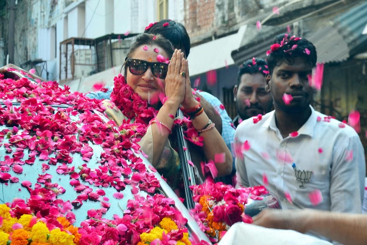 BJP parliamentary candidate from Rampur, Jaya Prada, greets party workers during an election rally ahead of the Lok Sabha elections. (PTI Photo)