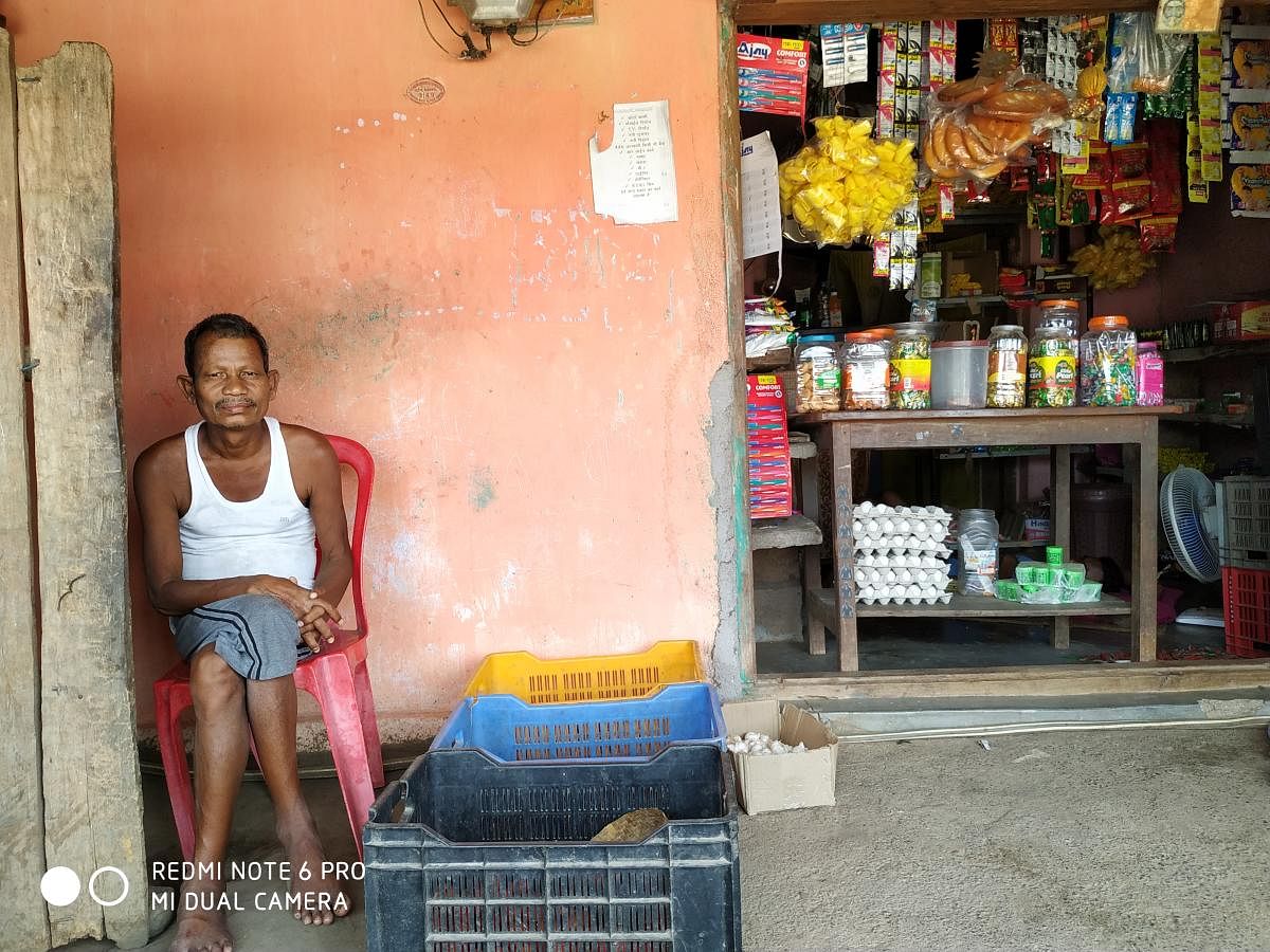50-year old Aitu Solam sitting in front of his shop at his house in Salwa Judum camp, Dornapal, Sukma.