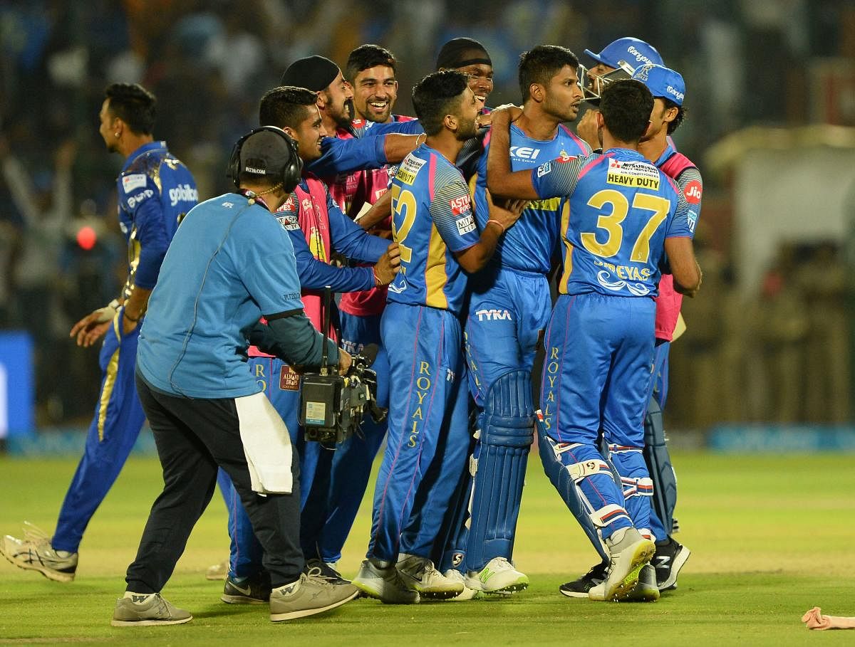 Rajasthan Royals' K Gowtham (centre) is mobbed by team-mates after he hit the winning runs against Mumbai Indians in Jaipur on Sunday. AFP