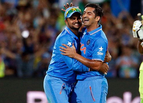 India's Suresh Raina (L) and bowler Mohit Sharma celebrate at the end of their Cricket World Cup match against Pakistan on Sunday. Reuters photo