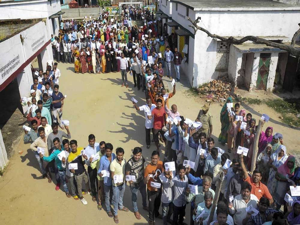 Moradabad: Voters wait in long queues to cast their votes at a polling station, during the third phase of Lok Sabha polls, in Moradabad, Tuesday. PTI photo