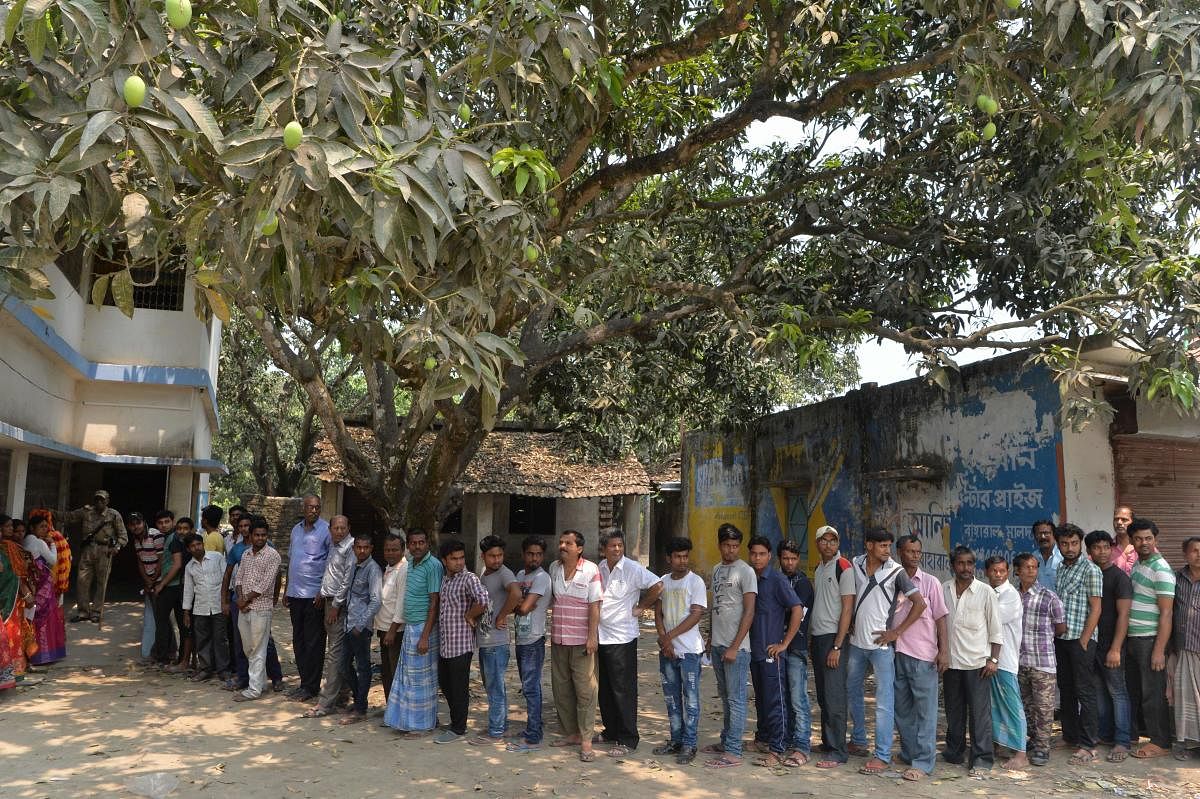 Voters queue up to cast their vote at a polling station in Malda in West Bengal, during the third phase of the mammoth elections. AFP photo