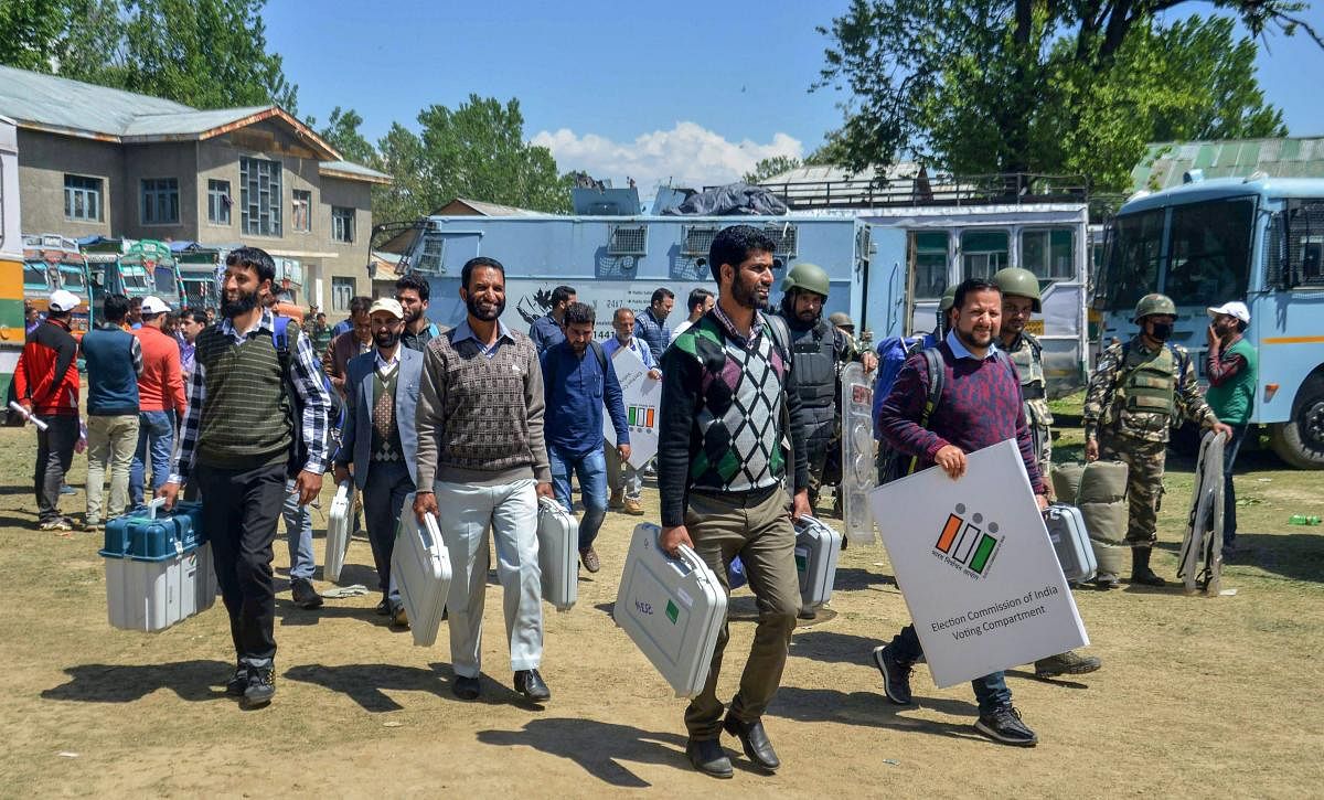 Election officials carry election material as they leave for their polling stations, on the eve of Lok Sabha elections, in Anantnag district, Monday, April 22, 2019. (PTI Photo)