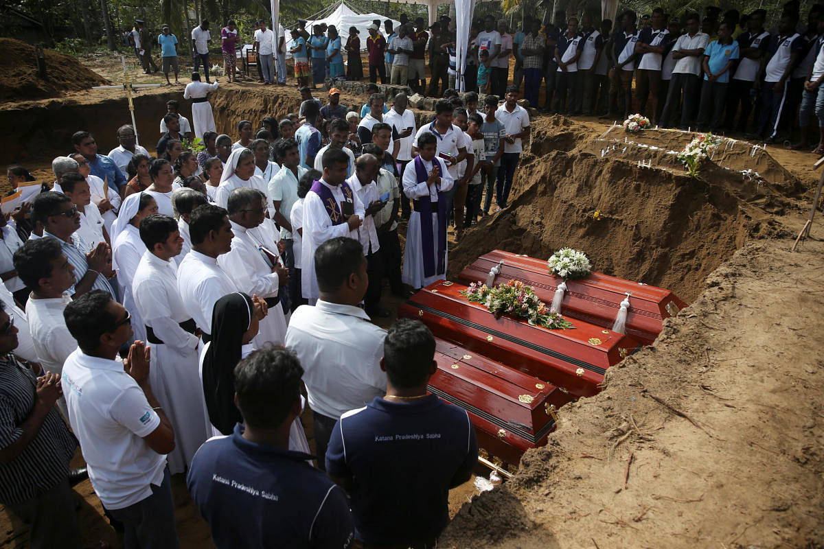 People attend a mass burial of victims, two days after a string of suicide bomb attacks on churches and luxury hotels across the island on Easter Sunday, at a cemetery near St. Sebastian Church in Negombo, Sri Lanka April 23, 2019. (REUTERS)