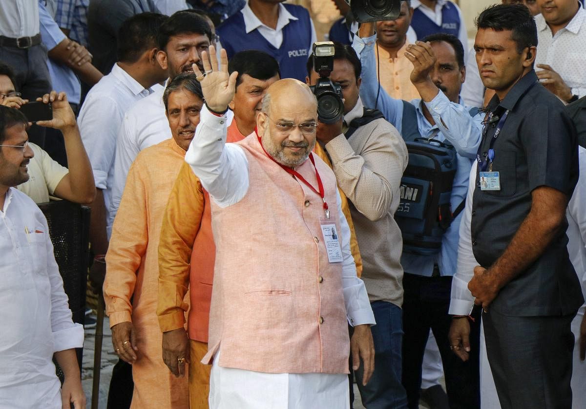 Ahmedabad: BJP President Amit Shah waves at supporters while waiting for Prime Minister Narendra Modi's arrival for casting his vote during the third phase of the 2019 Lok Sabha elections, in Ahmedabad, Tuesday, April 23, 2019. (PTI Photo)(PTI4_23_2019_00