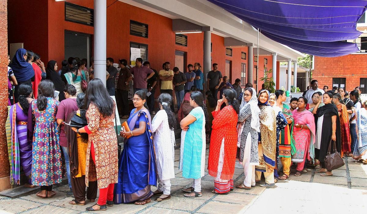 Women wait in a long queue to cast their votes at a polling station, during the third phase of Lok Sabha polls, in Kozhikode, Tuesday, April 23, 2019. (PTI Photo)