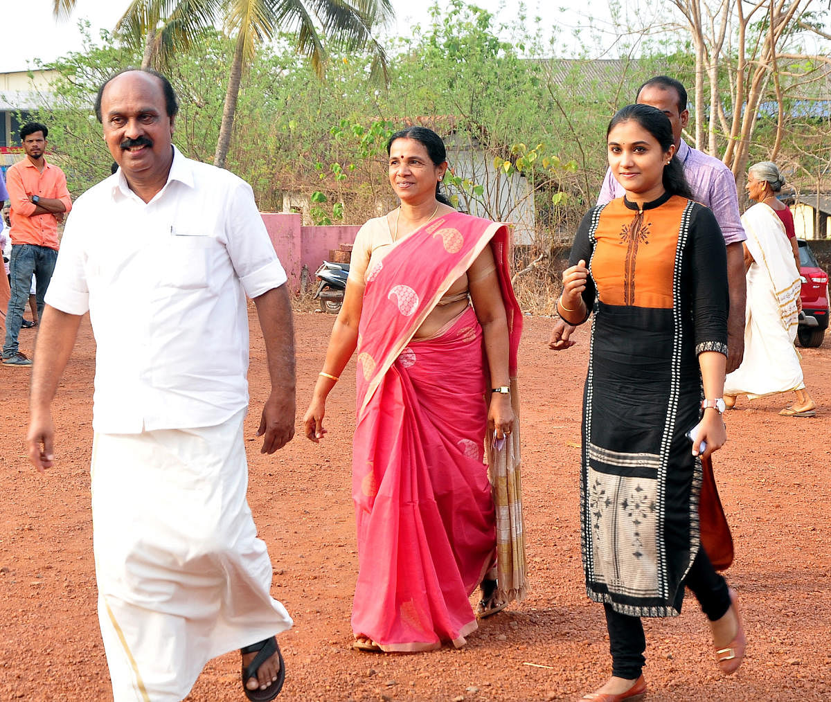 Revenue Minister E Chandrashekaran arrives along with his family members to the polling booth to exercise franchise.