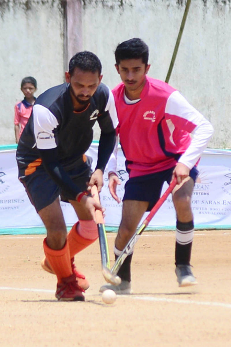 Players of Mandeera and Channapanda in action at the hockey tournament organised by The Highlanders Family Club at General K S Thimayya Stadium in Napoklu on Wednesday.