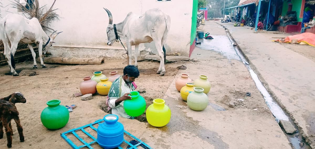 A resident of M Kodihalli in Kadur taluk collects water.