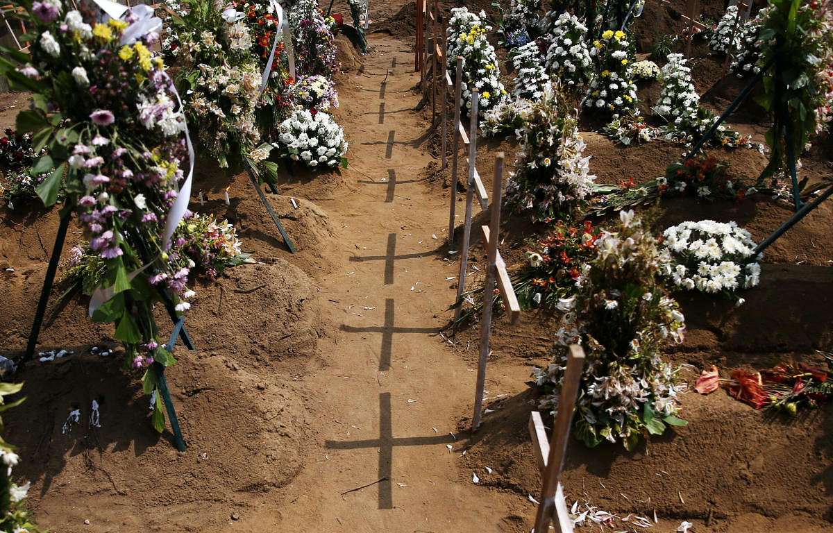 Crosses cast shadows at the site of a mass burial for victims of the suicide attacks on churches and luxury hotels in Negombo, Sri Lanka, April 25, 2019. (REUTERS)