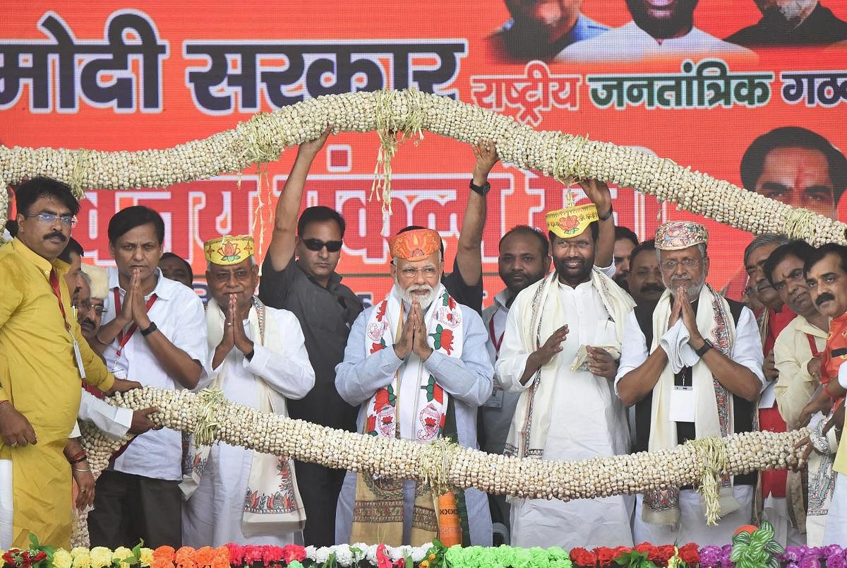 Prime Minister Narendra Modi is being garlanded along with Bihar Chief Minister and Janta Dal-United President Nitish Kumar, his deputy Sushil Kumar Modi, Lok Janshakti Party (LJP) chief Ram Vilas Paswan and others, during an election rally ahead of the L