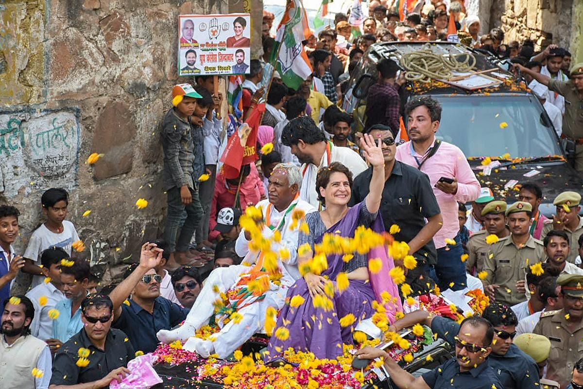 Congress General Secretary Priyanka Gandhi Vadra waves at the supporters during an election rally in support of the party candidate Shiv Sharan Kushwaha (to Priyanka's right), in Jhansi on Thursday. PTI