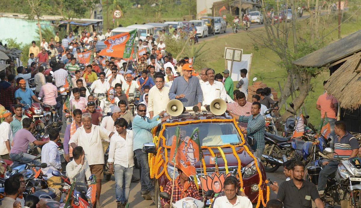  BJP parliamentary candidate Baijayant Panda waves at party workers during an election campaign roadshow for Lok Sabha polls, in Kendrapada district, Tuesday, April 16, 2019. (PTI Photo)