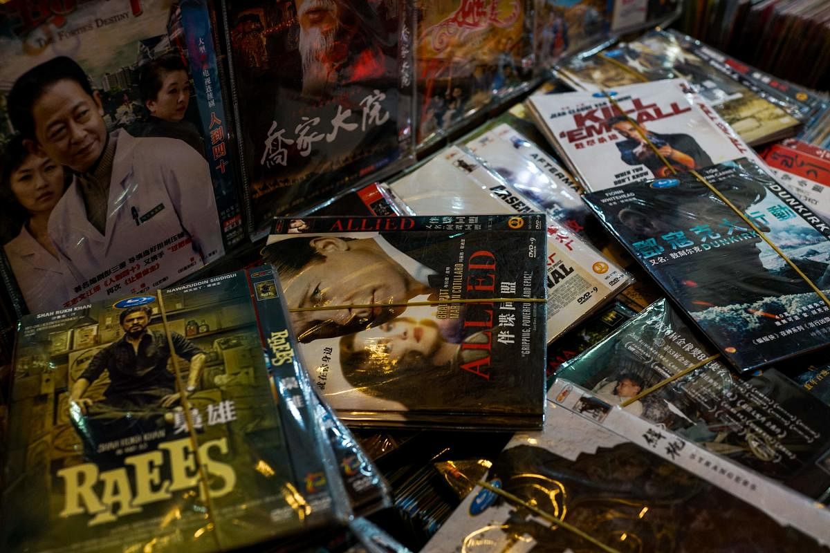Fake DVD's of American movies are displayed for sale in Shanghai on August 15, 2017. Trade tensions between the United States and China heated up on August 15 as Beijing warned that it "will not sit idle" if a US probe into its intellectual property pract