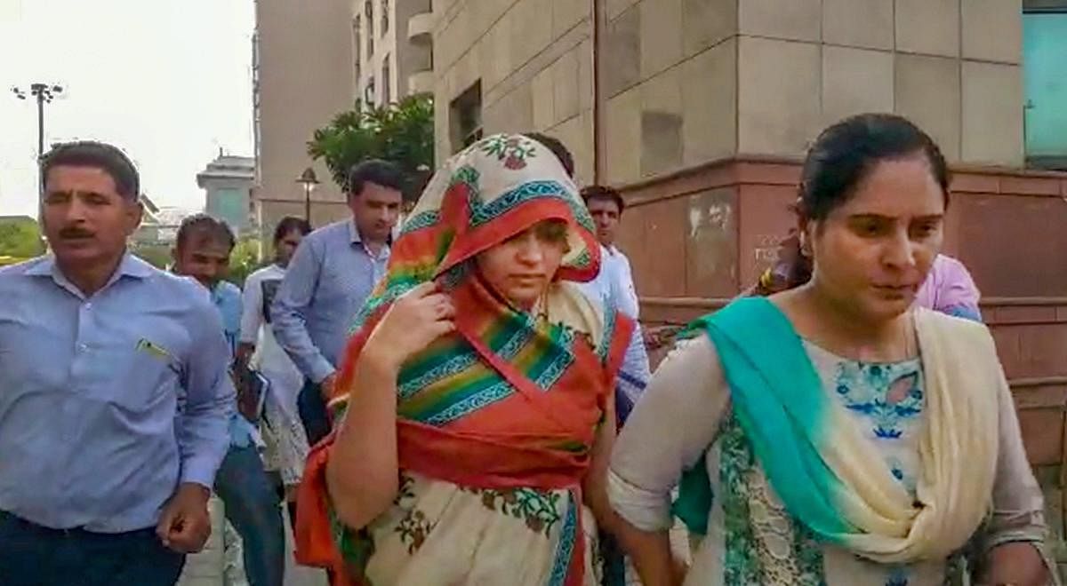 Apoorva Shukla Tiwari, accused of murdering her husband Rohit Shekhar Tiwari, being taken away after she was produced in a court in New Delhi. (PTI Photo)