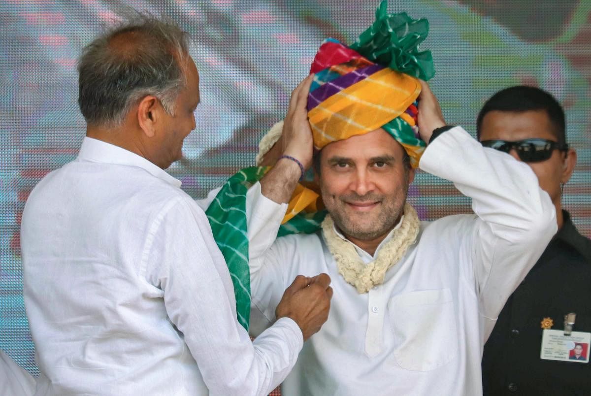 Congress President Rahul Gandhi being presented a turban by Rajasthan Chief Minister Ashok Gehlot during the election campaign rally at Bandanwara in Ajmer district on Thursday. PTI