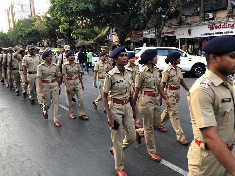 Police personnel conduct a route march in Thane district ahead of polling day. (DH Photo)