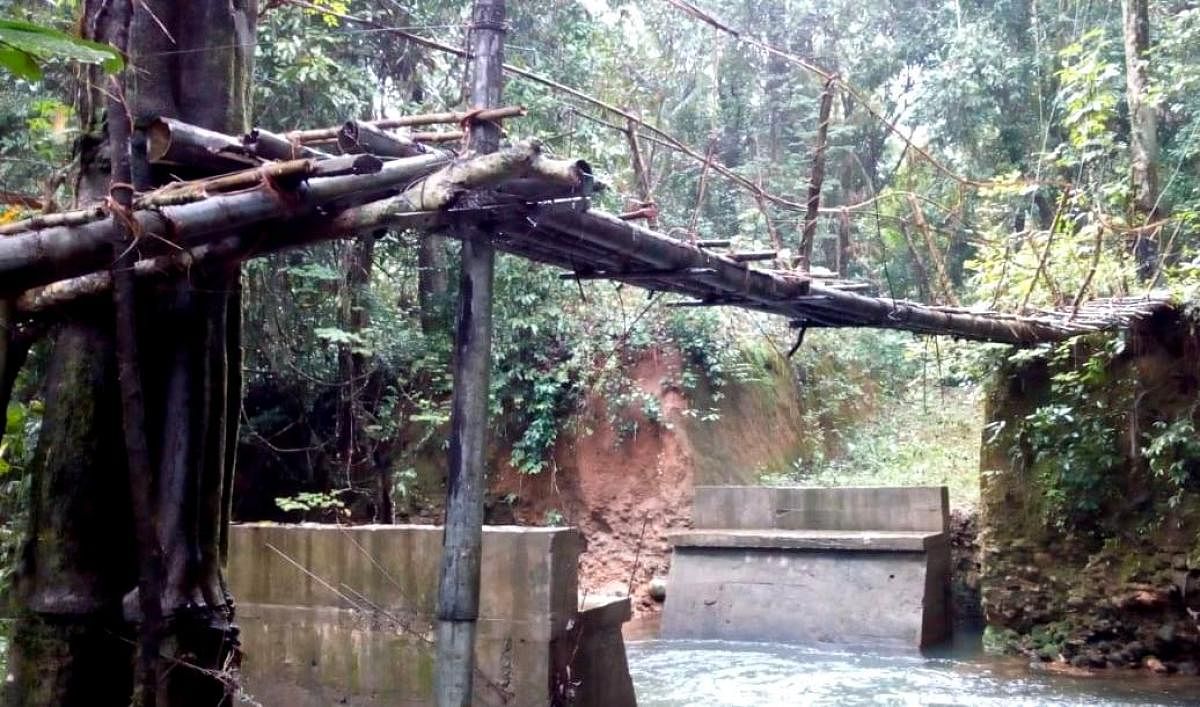 The incomplete work on a bridge near Kothnadka has forced the residents to use the hanging wooden bridge.