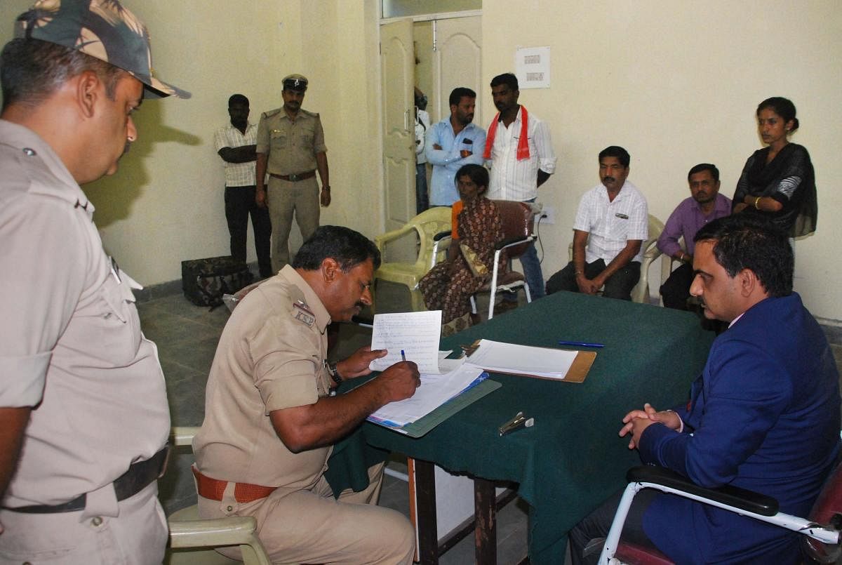 Sagar Gurugouda Patil, principal civil judge, Channarayapatna, conducts an inquiry in connection with a suspected custodial death, on Saturday. dh photo