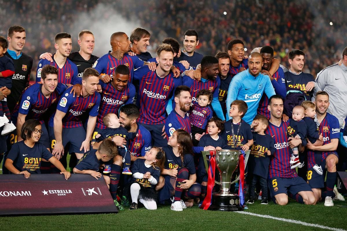 DOMINANT: Barcelona players celebrate becoming La Liga champions on Saturday. AFP
