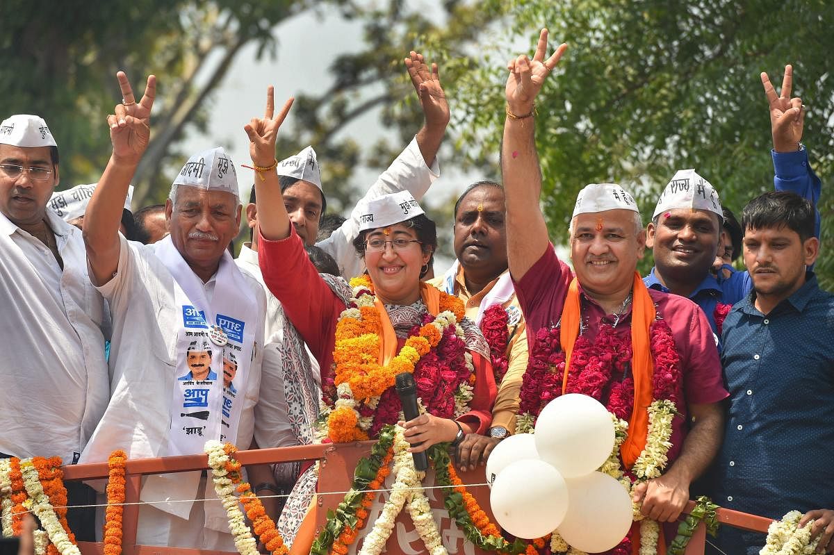 Aam Aadmi Party's (AAP) candidate from East Delhi, Atishi, with Delhi Dy Chief Minister Manish Sisodia shows victory sign. (PTI File Photo)