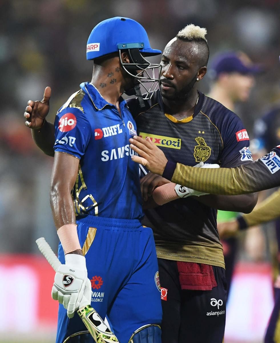 Andre Russell (R) congratulates Hardik Pandya (L) for his innings after Pandya lost his wicket during the 2019 Indian Premier League (IPL) Twenty 20 cricket match between Kolkata Knight Riders and Mumbai Indians at the Eden Gardens Cricket Stadium, in Kol