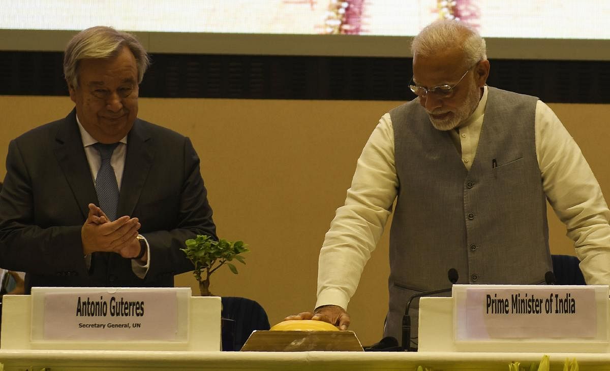 Prime Minister Narendra Modi (R) and United Nations Secretary General Antonio Guterres (L) gesture during the inaugural ceremony of the '2nd Global RE-INVEST India-ISA Partnership Renewable Energy Investors Meet &amp; Expo' in New Delhi on Tuesday. AFP
