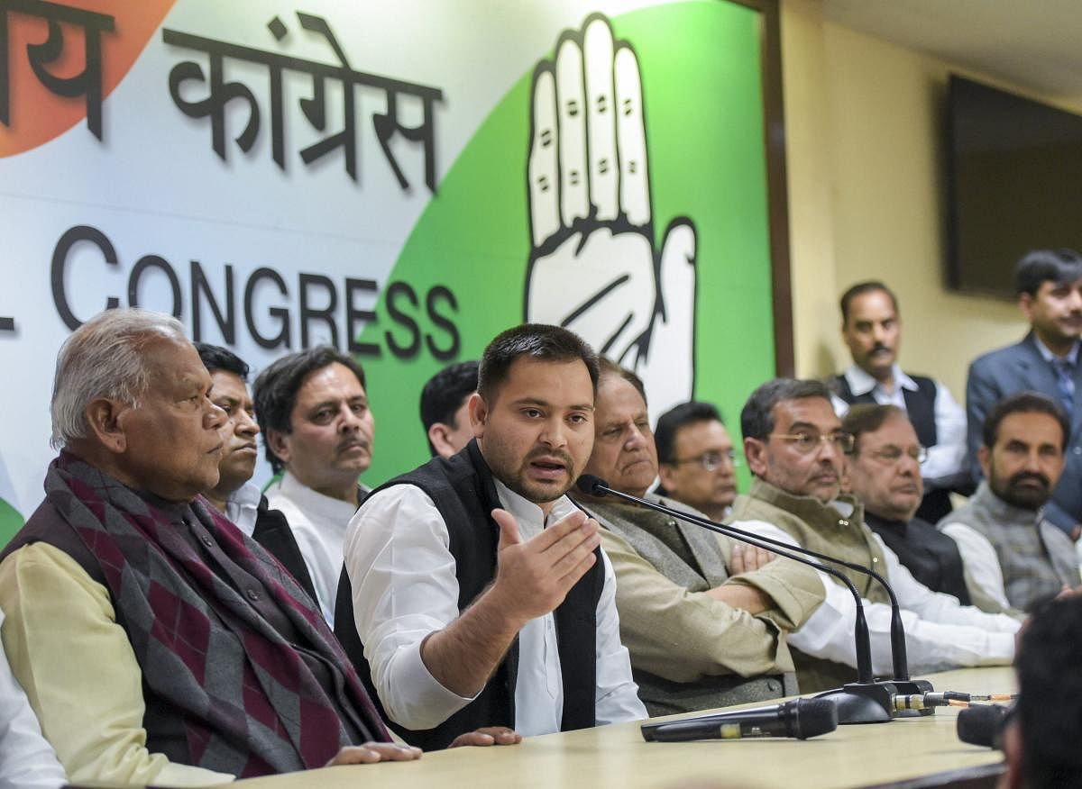 RJD's Tejashwi Yadav, along with other Mahagathbandhan leaders, speak during a press conference at which RLSP leader Upendra Kushwaha joined the grand alliance, at AICC in New Delhi on Thursday. PTI
