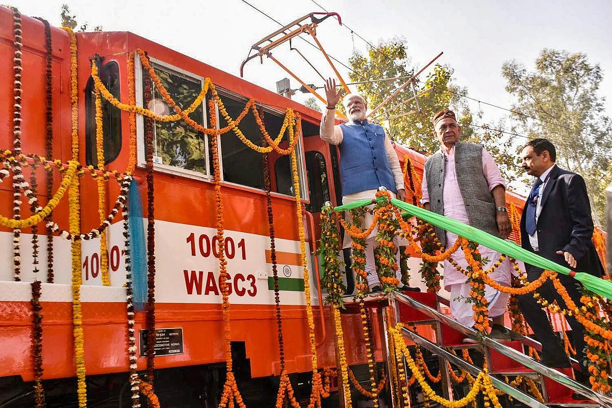 Prime Minister Narendra Modi flags off an electric locomotive converted from a diesel engine at Diesel Locomotive Works (DLW), in Varanasi. PTI photo
