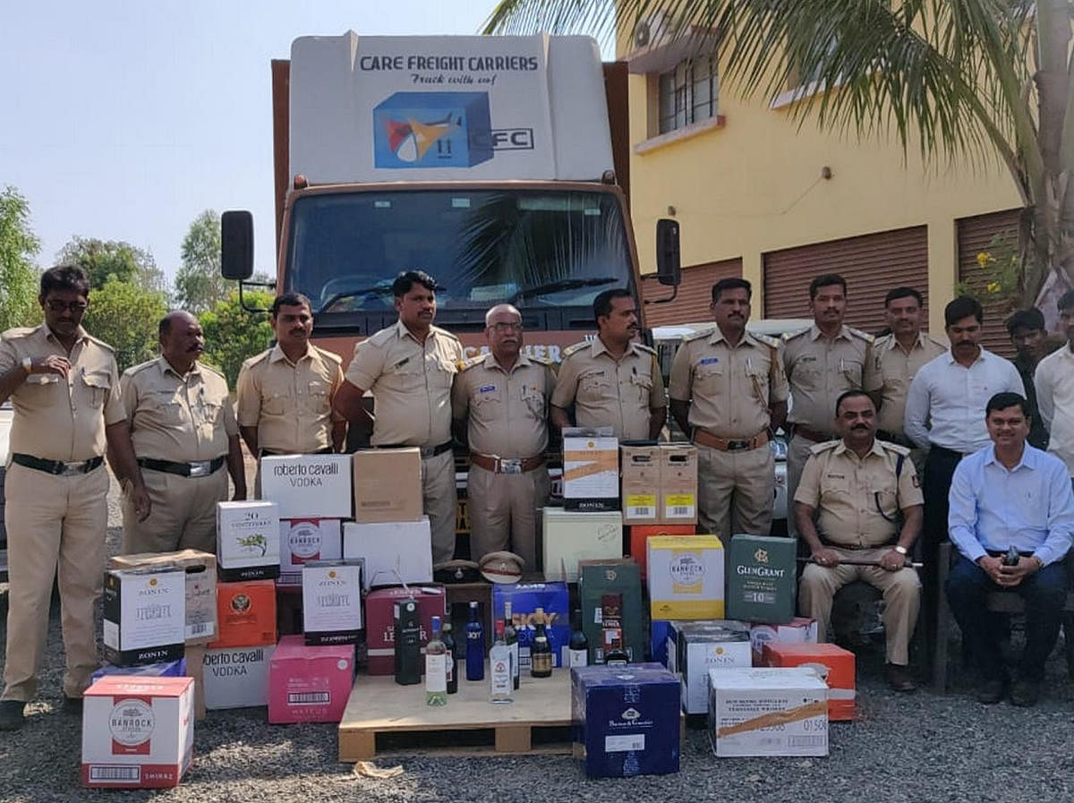 Electoral staff seize illegal liquor near Molakera village in Humnabad taluk, Bidar district, being transported in a container on Tuesday. (DH Photo)