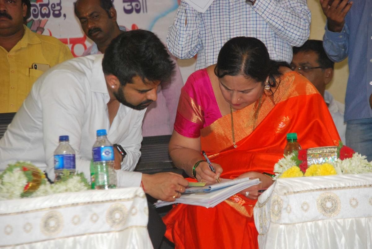Congress-JD(S) coalition candidate Prajwal with his mother and ZP member Bhavani Revanna, during a party workers' meeting, in Hassan, on Wednesday.