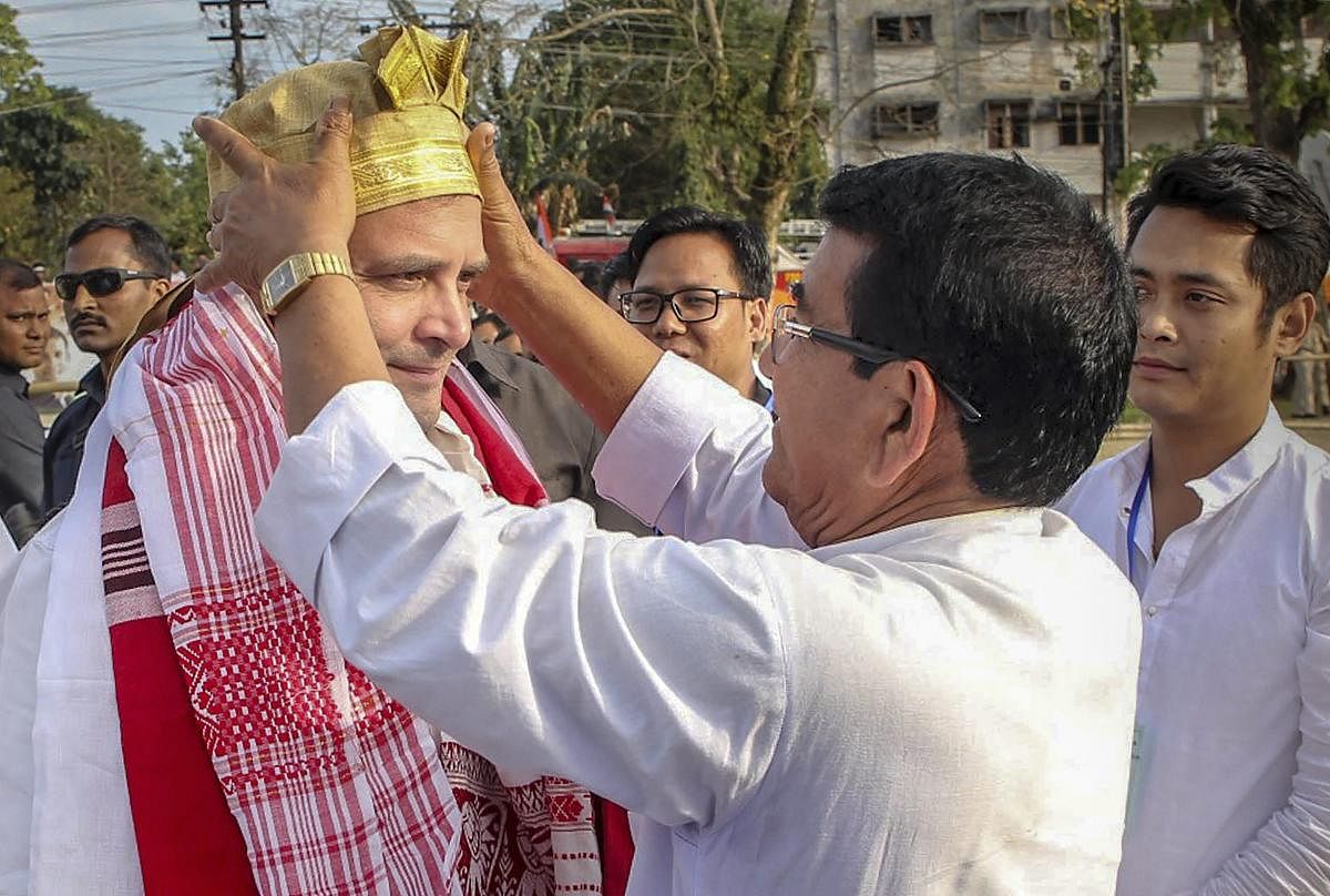 National Congress President Rahul Gandhi being welcomed on his arrival for an election campaign rally in Lakhimpur, Assam onWednesday. (PTI Photo)