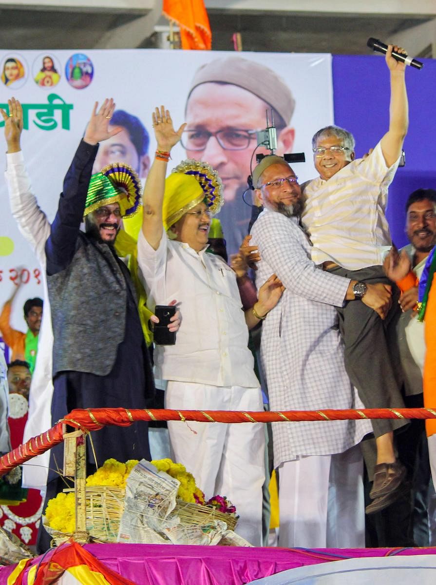 Solapur: AIMIM chief and Hyderabad MP, Asaduddin Owaisi carries Bharipa Bahujan Mahasangh leader Prakash Ambedkar during an election campaign rally for the Lok Sabha elections, in Solapur, Maharashtra, Wednesday, April 10, 2019. (PTI Photo)