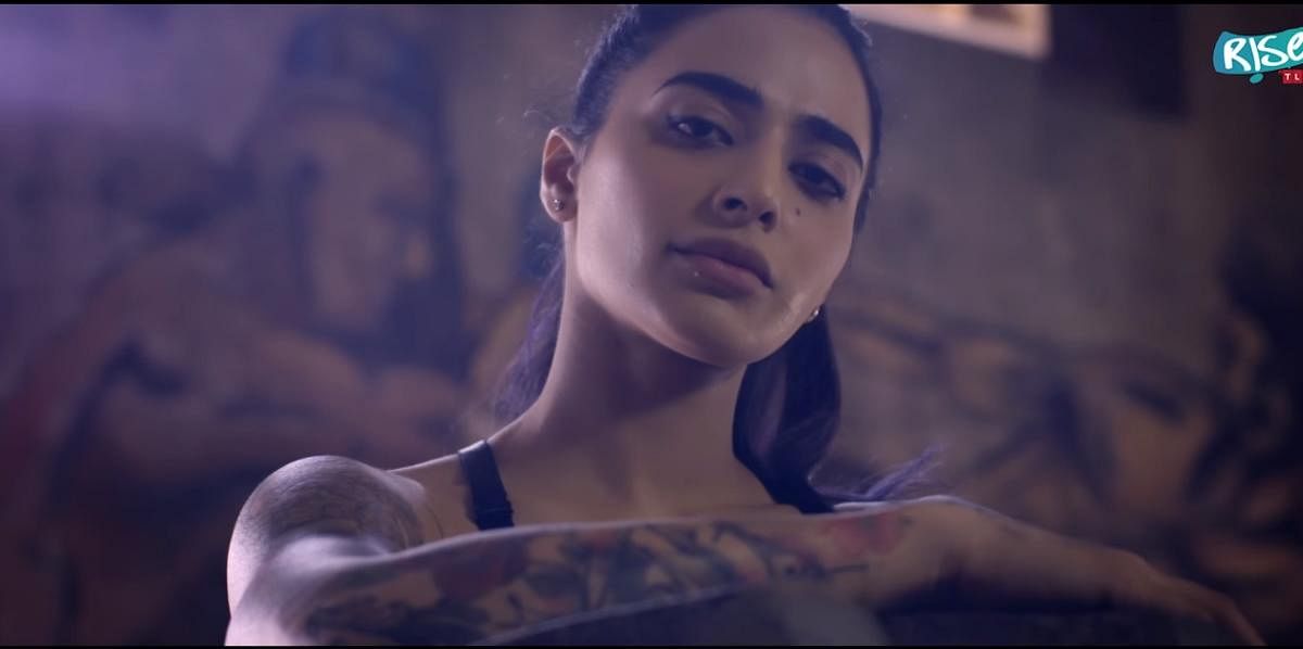 Bani J in her music video ‘Miss Judged’ has a dermal piercing below her lower lip.