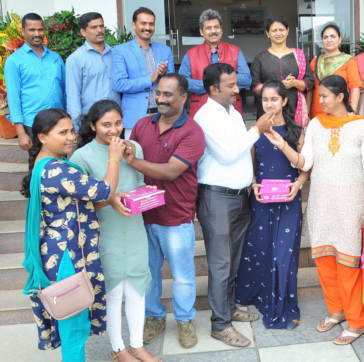 Bhumika Naidu C R and Yukta G Swamy, the district toppers in SSLC exams celebrate at St Mary's School, Chikkamagaluru, with their parents on Tuesday.