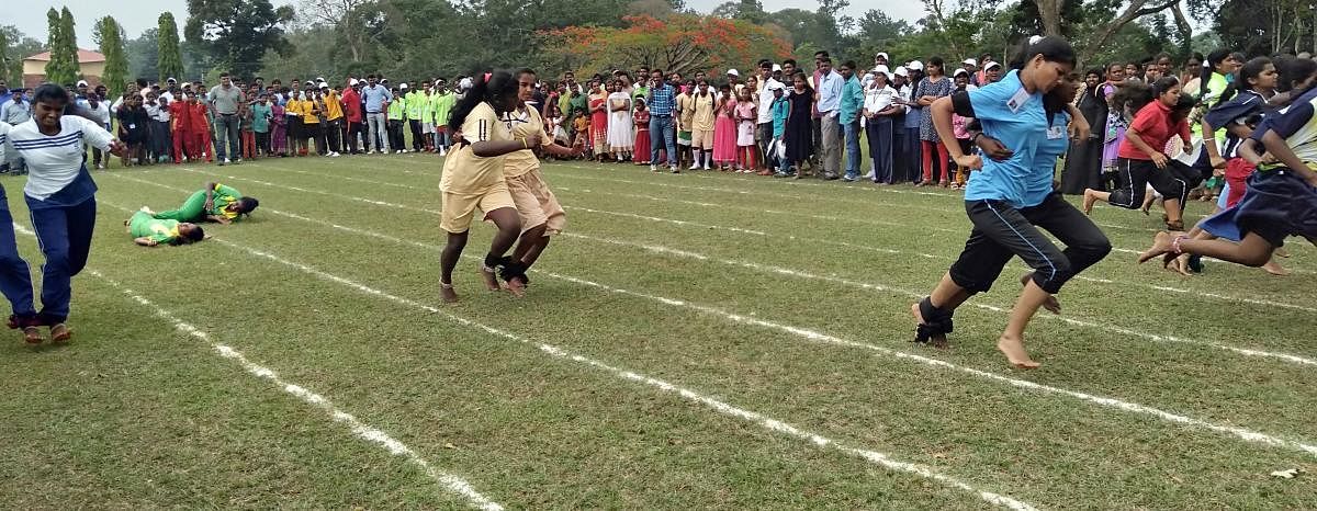 Women workers at Tata Coffee, Palibetta take part in a three-legged race organised by Tata Coffee on Wednesday.