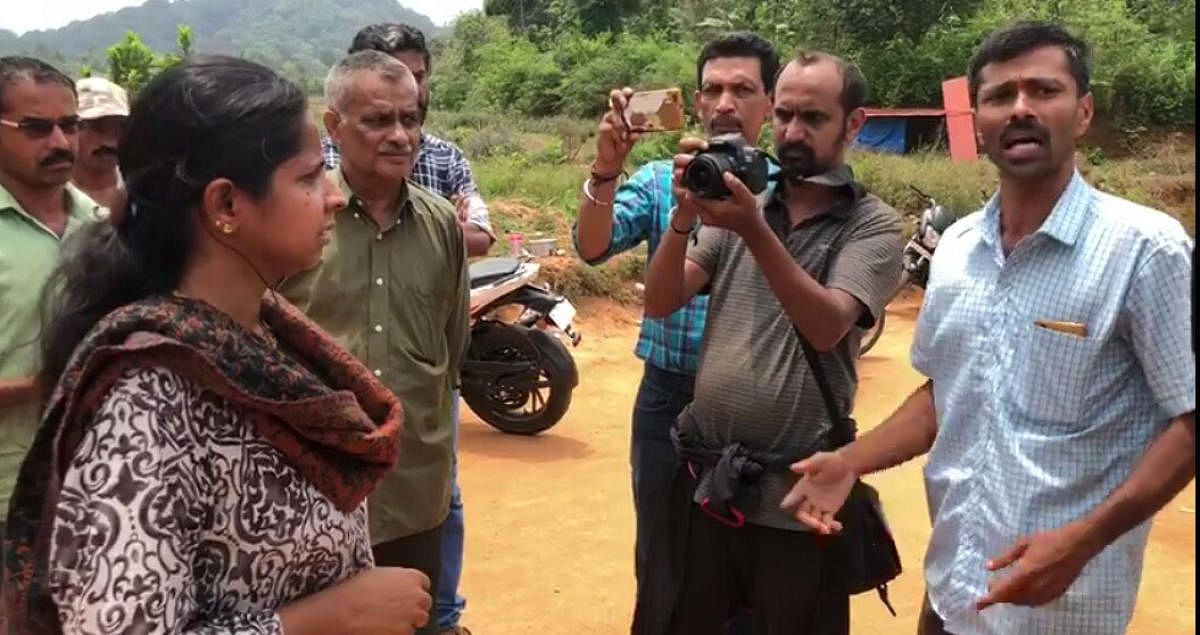 Residents of Kalooru village argue with officials of Mines and Geology Department.