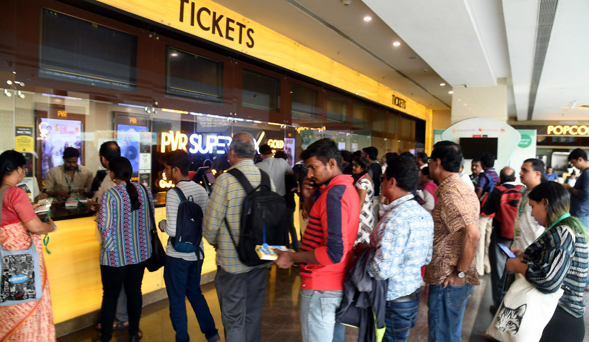 Movie buffs prefer to book their seats via online portals as they find it convenient. Many don’t pay attention to the additional internet charges. DH PHOTO BY B H SHIVAKUMAR