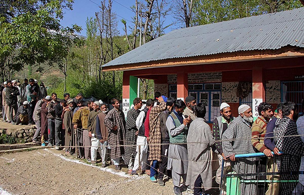 People wait in a long queue to cast their votes at a polling station, during the 4th phase of Lok Sabha elections, in Kulgam district of south Kashmir on April 29, 2019. (PTI Photo) 