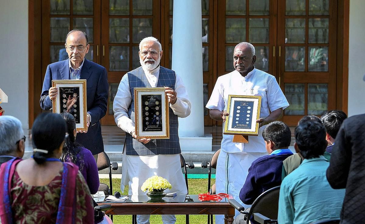 Prime Minister Narendra Modi releases a new series of visually impaired friendly circulation coins, at a function in New Delhi on Thursday. PTI
