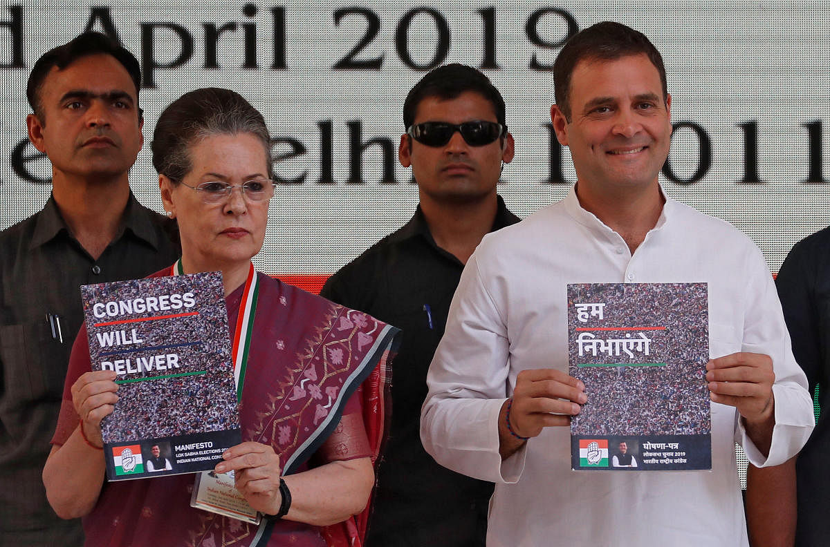 Rahul Gandhi, President of India's main opposition Congress party, and his mother and leader of the party Sonia Gandhi display copies of their party's election manifesto for the April/May general election in New Delhi, India, April 2, 2019. (REUTERS)