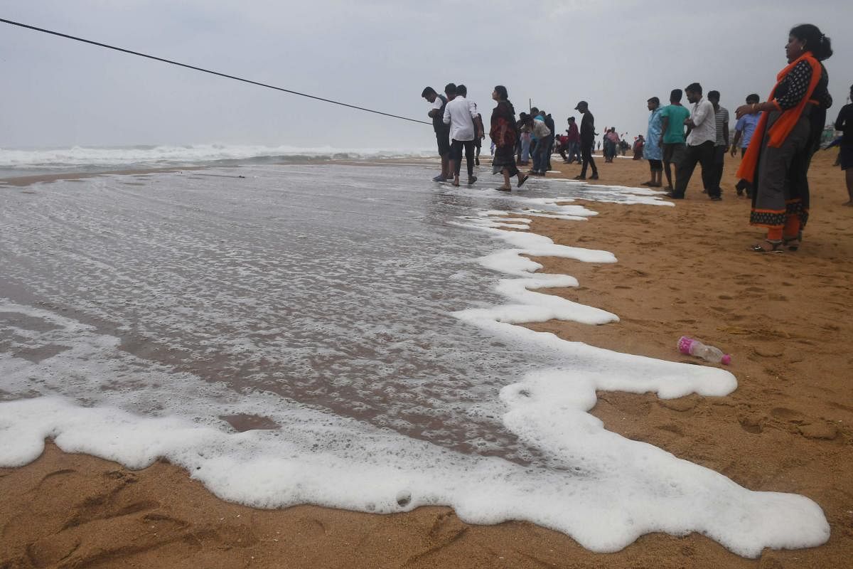 People look out towards the sea from a closed beach in Puri in the eastern state of Odisha. AFP