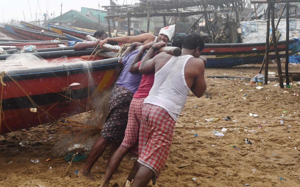 Fishermen pull a boat to higher ground on a beach in Puri in the eastern state of Odisha. AFP