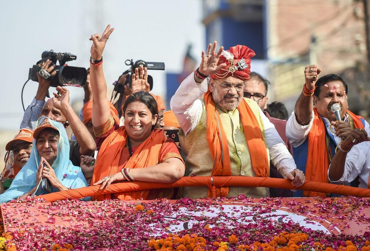  BJP National President Amit Shah during an election roadshow in support of party's candidate from Amethi seat Smriti Irani for Lok Sabha polls in Amethi on Saturday. PTI photo