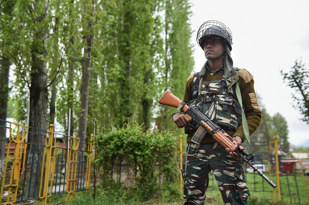 A security personnel stands guard outside an EVM distribution centre ahead of the second phase of Lok Sabha elections, in Srinagar, Wednesday, April 17, 2019. (PTI Photo)