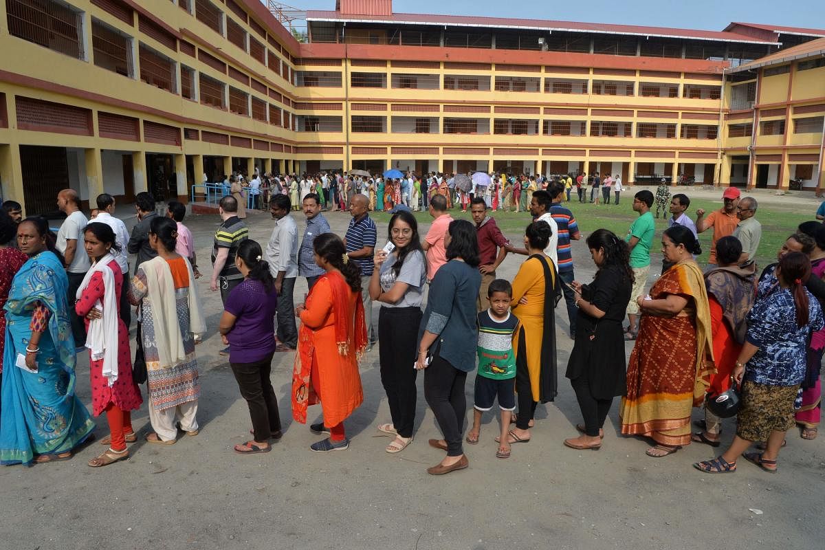 Voters queue up to cast their vote at a polling station in Siliguri, West Bengal on April 18, 2019, during the second phase of Lok Sabha elections. (AFP Photo)