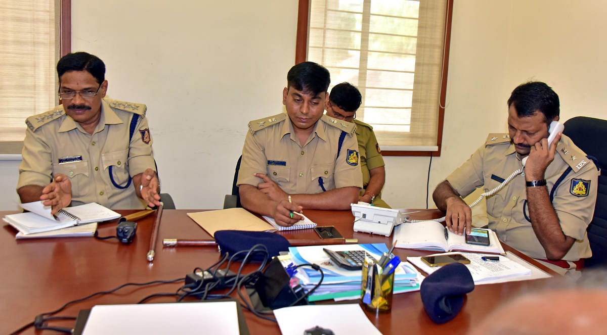DCP (Law and order) Hanumantaraya interacts with a caller during the weekly phone-in programme, in the office of Mangaluru City Police Commissionerate on Friday.